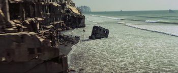 Movie still from “Inception” (2010), directed by Christopher Nolan – An old boat is washed up on the beach; Extreme Wide shot, High angle