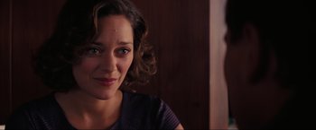 Movie still from “Inception” (2010), directed by Christopher Nolan – A woman's face in front of a wooden wall; Close Up shot, Over the shoulder angle