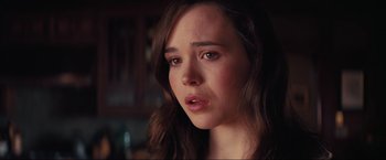 Movie still from “Inception” (2010), directed by Christopher Nolan – A person with long brown hair; Close Up shot, Over the shoulder angle