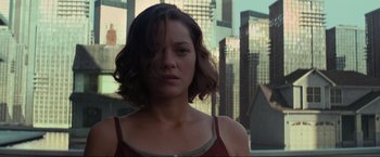 Movie still from “Inception” (2010), directed by Christopher Nolan – A person with a city in the background; Close Up shot, Low angle
