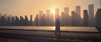 Movie still from “Inception” (2010), directed by Christopher Nolan – Two people standing next to each other near a body of water; Extreme Wide shot, Low angle
