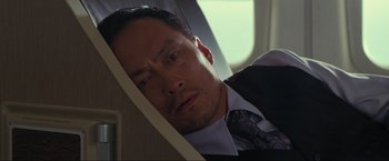 Movie still from “Inception” (2010), directed by Christopher Nolan – A person wearing a suit and tie; Close Up shot, Low angle