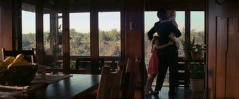 Movie still from “Inception” (2010), directed by Christopher Nolan – A man and a little girl standing in front of a window; Wide shot, Over the shoulder angle