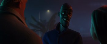Movie still from “Incredibles 2” (2018), directed by Brad Bird – A man in a blue jacket is smiling; Close Up shot, Over the shoulder angle