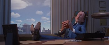 Movie still from “Incredibles 2” (2018), directed by Brad Bird – A man sitting at a table with his feet on the desk; Medium shot, Over the shoulder angle