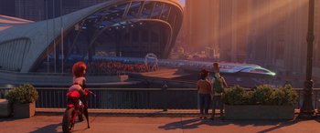 Movie still from “Incredibles 2” (2018), directed by Brad Bird – Two people standing on the side of a bridge looking at a crowd of onlookers; Extreme Wide shot, High angle