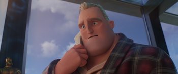 Movie still from “Incredibles 2” (2018), directed by Brad Bird – A man with blonde hair is talking on a cell phone; Close Up shot, Low angle