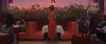Movie still from “Incredibles 2” (2018), directed by Brad Bird – A woman in a red dress standing in front of a table; Wide shot, Low angle