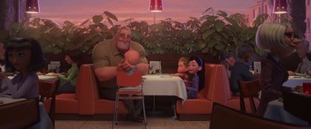Movie still from “Incredibles 2” (2018), directed by Brad Bird – A man and a little girl sitting at a table; Wide shot, Over the shoulder angle
