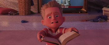Movie still from “Incredibles 2” (2018), directed by Brad Bird – A cartoon boy is holding an open book in his hands; Close Up shot, High angle