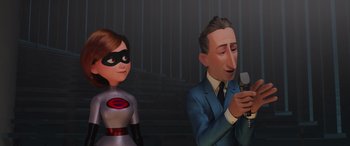 Movie still from “Incredibles 2” (2018), directed by Brad Bird – A man and a woman are standing next to each other; Medium shot, Over the shoulder angle