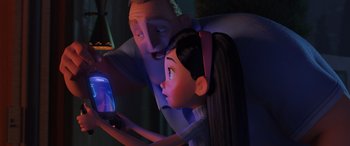 Movie still from “Incredibles 2” (2018), directed by Brad Bird – A man and a woman looking at a cell phone; Medium shot, Over the shoulder angle