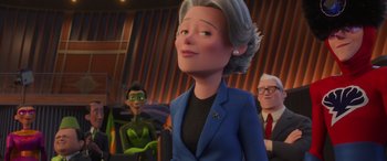 Movie still from “Incredibles 2” (2018), directed by Brad Bird – An animated woman in a blue jacket and a green tie; Close Up shot, Over the shoulder angle