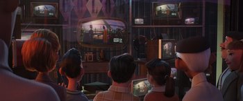 Movie still from “Incredibles 2” (2018), directed by Brad Bird – A group of people sitting in front of a television; Wide shot, Over the shoulder angle