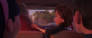 Movie still from “Incredibles 2” (2018), directed by Brad Bird – A woman sitting in the back seat of a car; Close Up shot, Over the shoulder angle