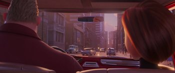 Movie still from “Incredibles 2” (2018), directed by Brad Bird – A view from inside a car looking out the window at a busy street; Wide shot, Over the shoulder angle
