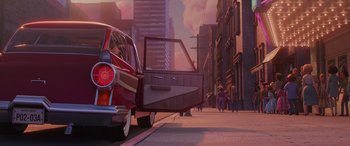 Movie still from “Incredibles 2” (2018), directed by Brad Bird – A car parked on the side of the road with people walking by; Wide shot, Low angle