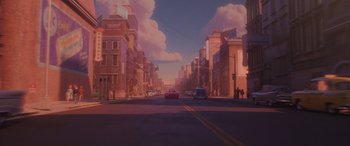 Movie still from “Incredibles 2” (2018), directed by Brad Bird – An image of a street with cars driving down the street; Extreme Wide shot, Low angle