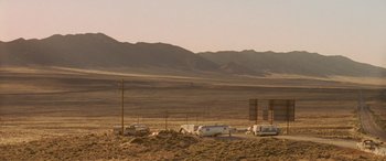 Movie still from “Independence Day” (1996), directed by Roland Emmerich – An rv park in the middle of a desert with mountains in the background; Extreme Wide shot, Low angle