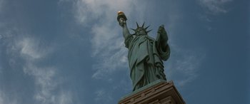 Movie still from “Independence Day” (1996), directed by Roland Emmerich – The statue of liberty is lit up by a candle in the sky; Extreme Wide shot, Low angle