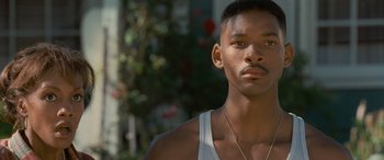 Movie still from “Independence Day” (1996), directed by Roland Emmerich – A person wearing a tank top; Close Up shot, Low angle