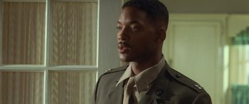 Movie still from “Independence Day” (1996), directed by Roland Emmerich – A man in a military uniform looking to his left; Close Up shot, Over the shoulder angle