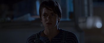 Movie still from “Independence Day” (1996), directed by Roland Emmerich – A young boy is looking into the camera; Close Up shot, Low angle