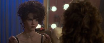 Movie still from “Independence Day” (1996), directed by Roland Emmerich – A person in a room with lights in the background; Close Up shot, Over the shoulder angle