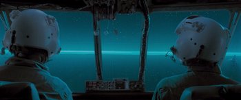 Movie still from “Independence Day” (1996), directed by Roland Emmerich – A view from inside an airplane looking out at the earth; Extreme Wide shot, Over the shoulder angle