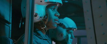 Movie still from “Independence Day” (1996), directed by Roland Emmerich – A man with a helmet on is looking at the camera; Close Up shot, Low angle