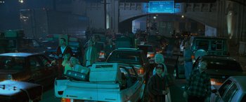 Movie still from “Independence Day” (1996), directed by Roland Emmerich – A group of people standing next to cars on a street; Wide shot, High angle