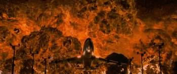Movie still from “Independence Day” (1996), directed by Roland Emmerich – An airplane is flying through the sky on a cloudy day; Extreme Wide shot, Low angle