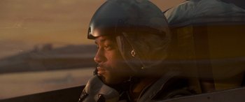 Movie still from “Independence Day” (1996), directed by Roland Emmerich – A person wearing a motorcycle helmet; Close Up shot, Low angle