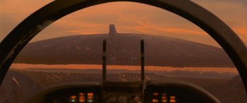 Movie still from “Independence Day” (1996), directed by Roland Emmerich – A view from a cockpit of an airplane at sunset; Extreme Wide shot, Low angle
