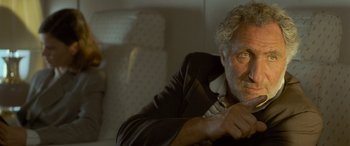 Movie still from “Independence Day” (1996), directed by Roland Emmerich – An older man is sitting in a chair; Close Up shot, Low angle