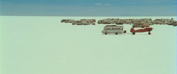 Movie still from “Independence Day” (1996), directed by Roland Emmerich – A group of recreational vehicles parked in the middle of the desert; Extreme Wide shot, High angle