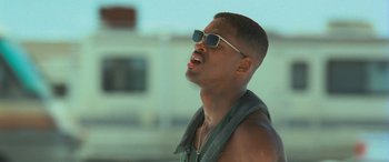 Movie still from “Independence Day” (1996), directed by Roland Emmerich – A young man wearing sunglasses and a leather vest; Close Up shot, Low angle
