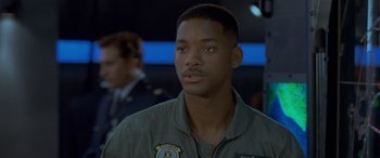 Movie still from “Independence Day” (1996), directed by Roland Emmerich – A man in a green jacket is looking to his left; Close Up shot, Low angle