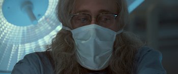 Movie still from “Independence Day” (1996), directed by Roland Emmerich – A person wearing a face mask and glasses; Close Up shot, Low angle