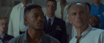 Movie still from “Independence Day” (1996), directed by Roland Emmerich – Two men standing next to each other in front of a group; Close Up shot, Low angle
