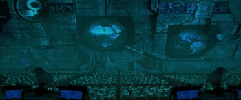 Movie still from “Independence Day” (1996), directed by Roland Emmerich – People are sitting in front of a projection of a globe; Extreme Wide shot, High angle