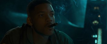 Movie still from “Independence Day” (1996), directed by Roland Emmerich – A young man is smoking a cigar in the dark; Close Up shot, Low angle