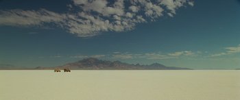 Movie still from “Independence Day” (1996), directed by Roland Emmerich – A person standing in the middle of an empty desert; Extreme Wide shot, Low angle