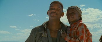 Movie still from “Independence Day” (1996), directed by Roland Emmerich – A man and a boy smiling for the camera; Close Up shot, Low angle