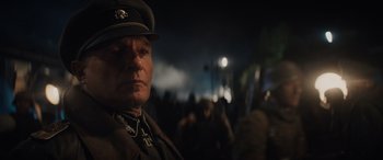 Movie still from “Indiana Jones and the Dial of Destiny” (2023), directed by James Mangold – A man in a military uniform is looking into the camera; Close Up shot, Over the shoulder angle