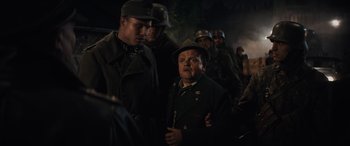 Movie still from “Indiana Jones and the Dial of Destiny” (2023), directed by James Mangold – A group of men standing next to each other; Medium shot, Over the shoulder angle