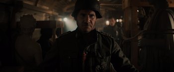 Movie still from “Indiana Jones and the Dial of Destiny” (2023), directed by James Mangold – A man wearing a military uniform and a helmet; Close Up shot, Low angle