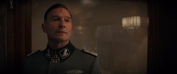 Movie still from “Indiana Jones and the Dial of Destiny” (2023), directed by James Mangold – A person wearing a uniform; Close Up shot, Low angle