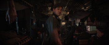 Movie still from “Indiana Jones and the Dial of Destiny” (2023), directed by James Mangold – A man in military uniform standing in a room; Medium shot, Over the shoulder angle