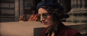 Movie still from “Indiana Jones and the Dial of Destiny” (2023), directed by James Mangold – A woman wearing a hat and sunglasses; Close Up shot, Over the shoulder angle